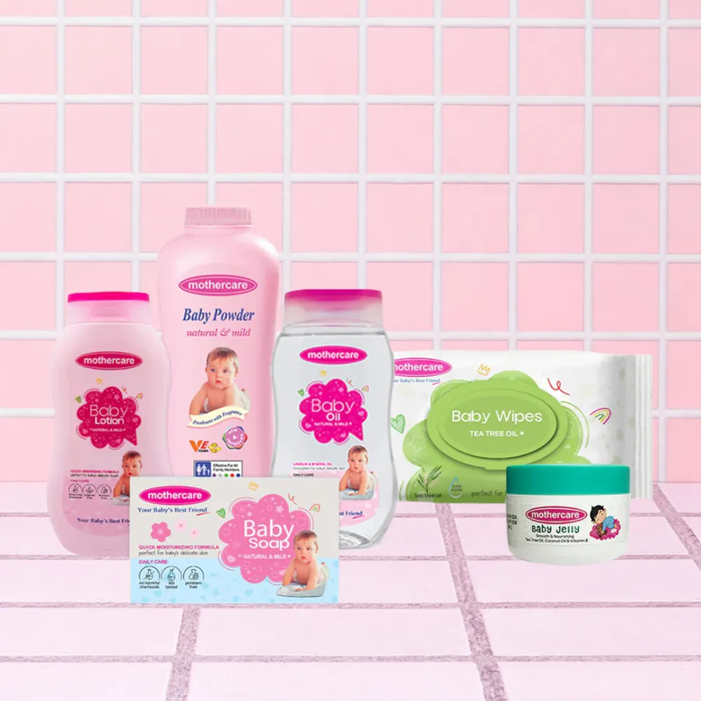Mothercare Essential Care Kit Includes Mothercare Baby Care Range Baby Lotion, Baby Powder, Baby Oil, Baby Wipes, Baby Soap, And Baby Jelly, All Center Placed on a Tile like Background in Pink Color