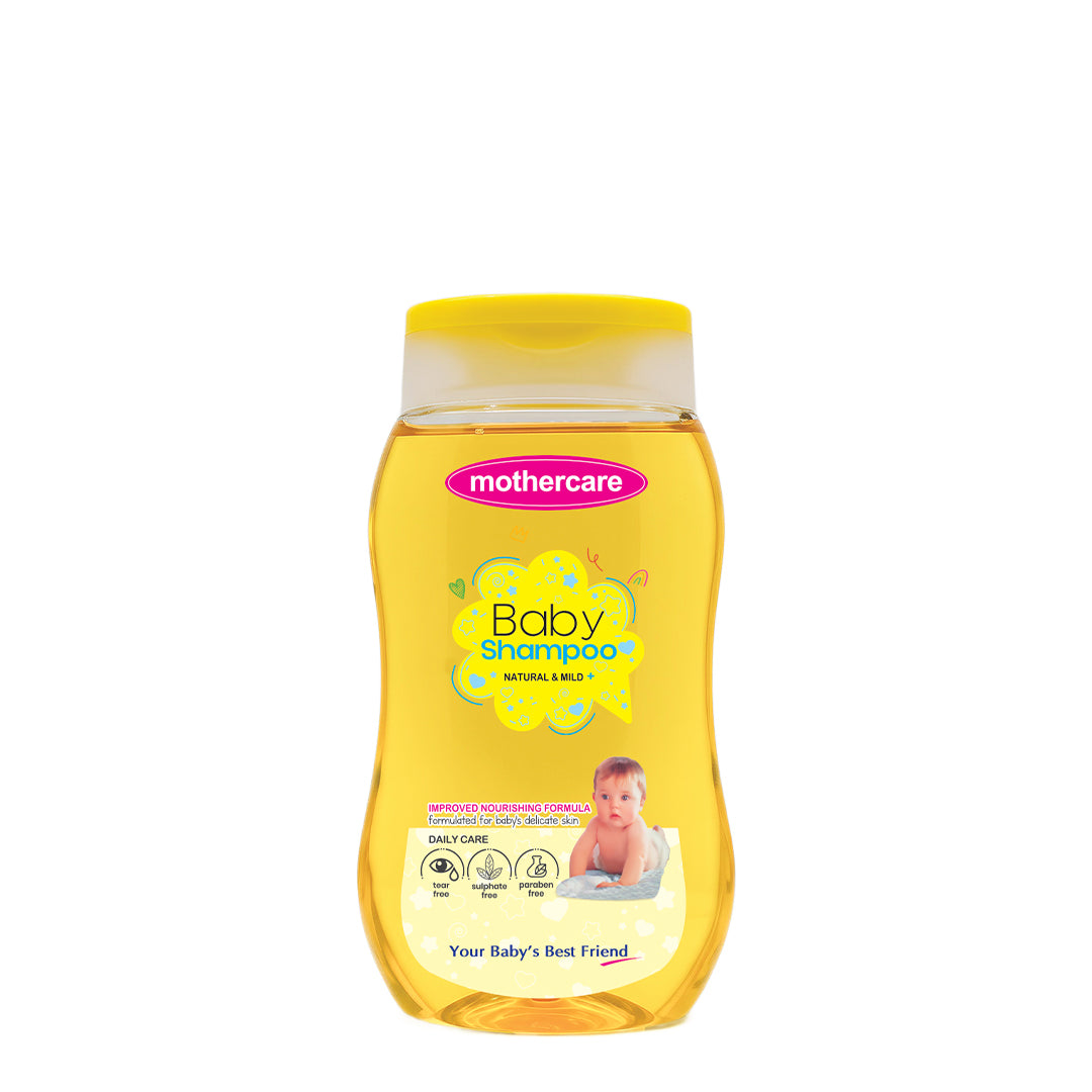 A bottle of Mothercare Natural & Mild Baby Shampoo with yellow liquid and a yellow cap, set against a plain white background.