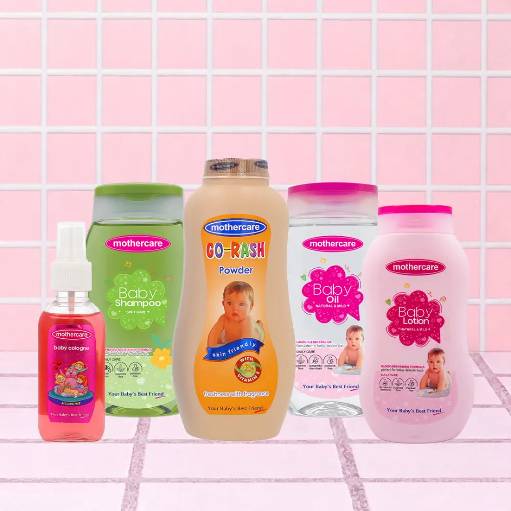 Mothercare Baby Travel Essentials Bundle Includes, Baby Cologne, Baby Shampoo, Baby Rash Powder, Baby Oil, Baby Lotion, All Center Placed n a Tile Like Background in Pink Color.